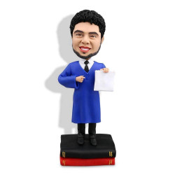 personalized male graduates in dark blue gown displaying diploma custom graduation bobblehead gift