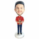 male rugby player in red t-shirt and holding a rugby custom figure bobblehead